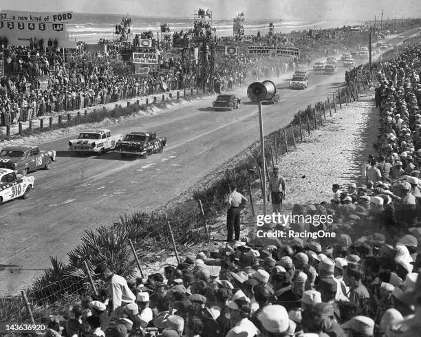 February 17, 1957: The field of cars head south down highway A1A as they line up behind the pace car prior to the start of the NASCAR Cup race on the...