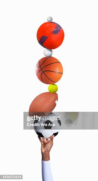 hand with pile of sports balls - matériel de sport photos et images de collection