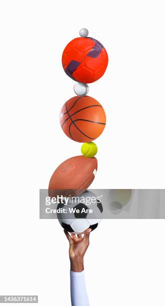 hand with pile of sports balls - sports equipment isolated stock pictures, royalty-free photos & images