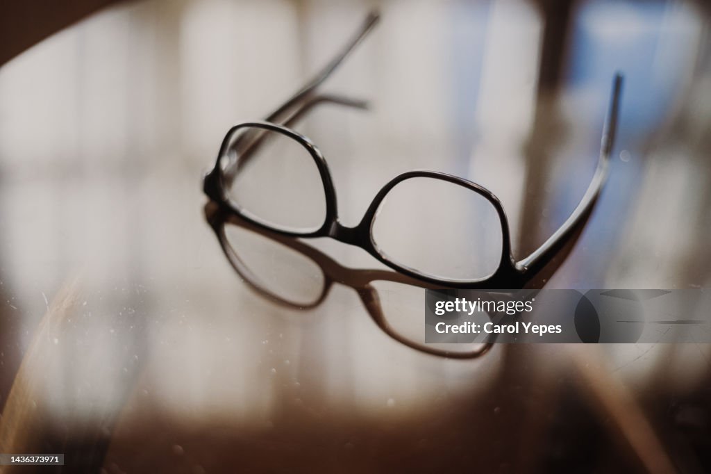 Eyeglasses with shadow on table at home