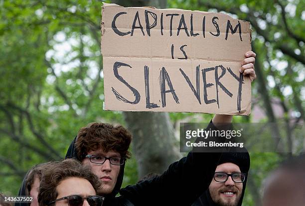 Demonstrators affiliated with the Occupy Wall Street movement protest in New York, U.S., on Tuesday, May 1, 2012. Occupy Wall Street demonstrators,...