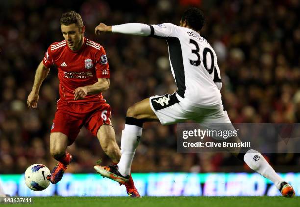 Mousa Dembele of Fulham challenges Fabio Aurelio of Liverpool during the Barclays Premier League match between Liverpool and Fulham at Anfield on May...