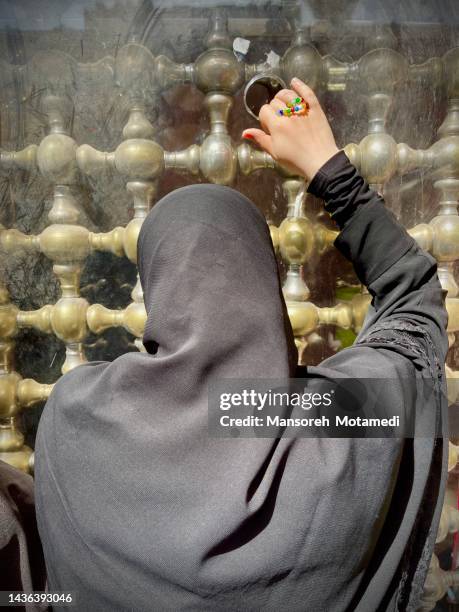 an muslim woman is praying in holy shrine of imam ali in najaf - shi'ite islam ストックフォトと画像