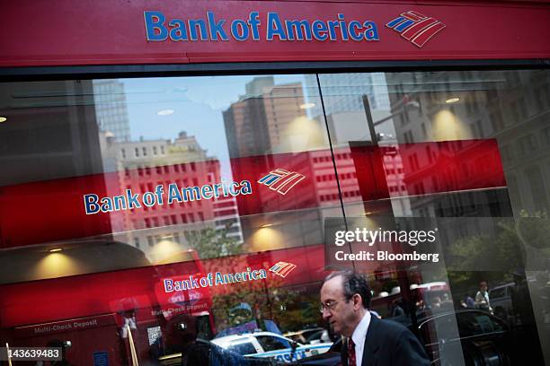 Pedestrians walk past a Bank of America Corp. Branch in New York, U.S., on Monday, April 30, 2012. Calls for a general strike with no work, no...