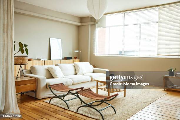 folding portable stool on carpet at home - woonkamer stockfoto's en -beelden