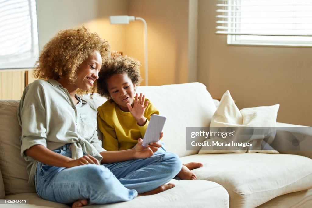 Boy and mother on video call through mobile phone