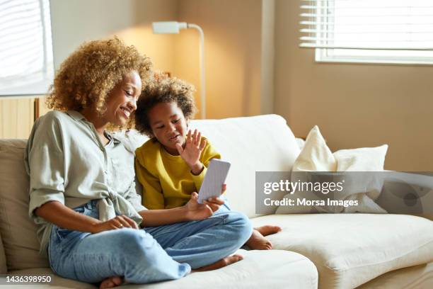 boy and mother on video call through mobile phone - child on phone stock pictures, royalty-free photos & images