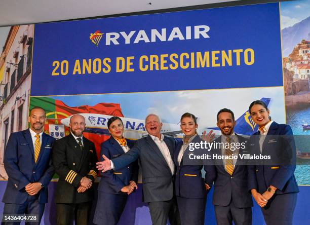 The CEO of Ryanair DAC Eddie Wilson gestures while poseing onstage for pictures with Lisbon base personnel at the end of the company's event on...
