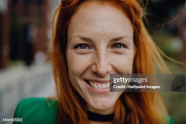portrait of young redhead woman outdoor. - mujeres de mediana edad fotografías e imágenes de stock