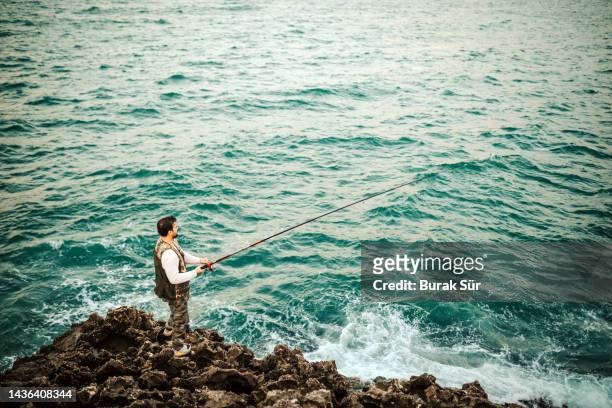 fishing season , fishing man , weekend activity , men lifestyle and hobby - surf casting stock pictures, royalty-free photos & images