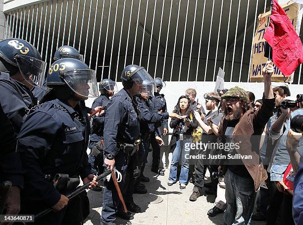 Oakland police officers make a line in front of Occupy protesters that are attempting to block a street on May 1, 2012 in Oakland, California. Occupy...