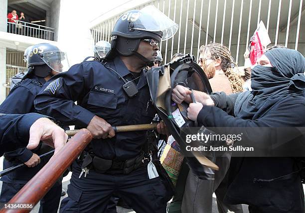 Oakland police officers use batons to push back Occupy protesters that are attempting to block a street on May 1, 2012 in Oakland, California. Occupy...