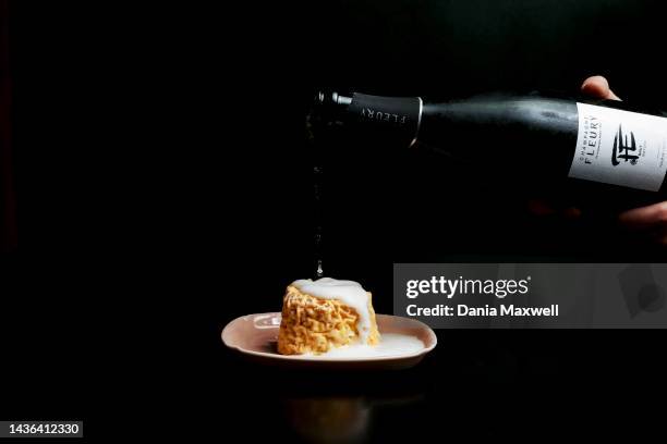 Champagne Fleury being poured over Langres cheese at Kippered Bar is photographed for Los Angeles Times on April 5, 2022 in Los Angeles, California....