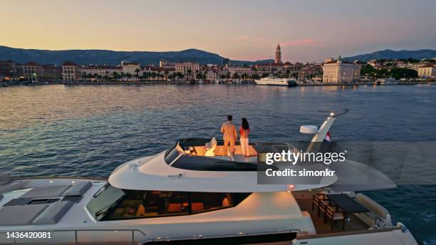 couple standing on yacht - super yacht stock pictures, royalty-free photos & images
