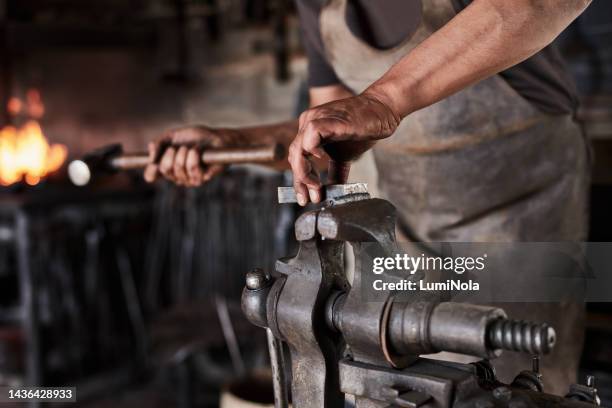 man, hands and metal bench vice in manufacturing warehouse, factory plant or industrial workshop. zoom, engineering or blacksmith with steel equipment for industry working labor mechanic with hammer - art smith stock pictures, royalty-free photos & images