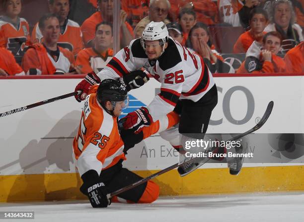 Patrik Elias of the New Jersey Devils flies over Matt Carle of the Philadelphia Flyers during the first period in Game Two of the Eastern Conference...