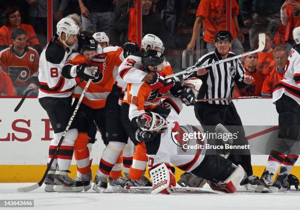 Danny Briere of the Philadelphia Flyers pulls down Martin Brodeur of the New Jersey Devils during a first period altercation in Game Two of the...
