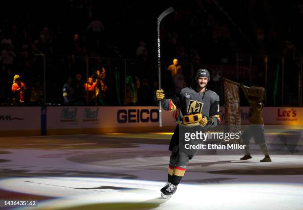 Nicolas Roy of the Vegas Golden Knights prepares to toss a poker chip-themed pillow to fans after being named the third star of the game following...