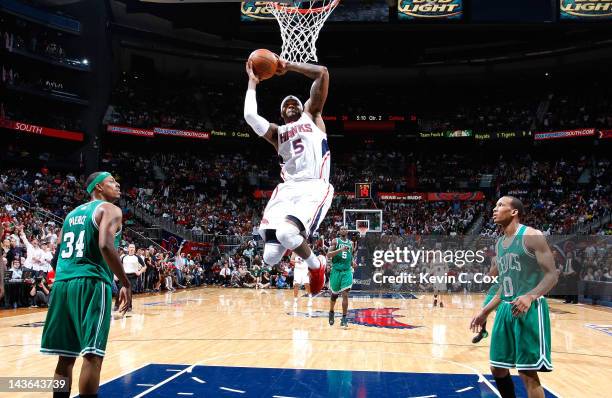 Josh Smith of the Atlanta Hawks dunks between Paul Pierce and Avery Bradley of the Boston Celtics in Game Two of the Eastern Conference Quarterfinals...