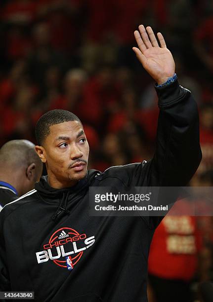 Derrick Rose of the Chicago Bulls, injured in game one against the Philadelphia 76ers, waves to the crowd before Game Two of the Eastern Conference...