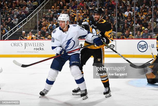 Corey Perry of the Tampa Bay Lightning battles for position against Pierre-Olivier Joseph of the Pittsburgh Penguins during the game at PPG PAINTS...
