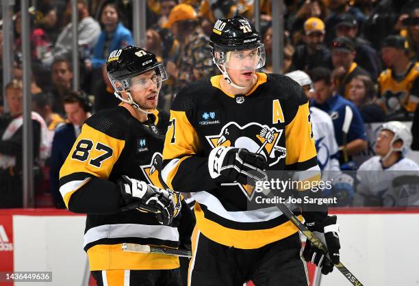 Sidney Crosby talks with Evgeni Malkin of the Pittsburgh Penguins during the game against the Tampa Bay Lightning at PPG PAINTS Arena on October 15,...