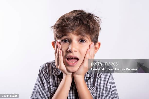 photo of expressive scaring boy looking at camera scared - somente crianças imagens e fotografias de stock