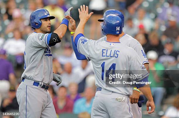 Andre Ethier of the Los Angeles Dodgers is welcomed home by Matt Kemp of the Los Angeles Dodgers and Mark Ellis of the Los Angeles Dodgers who scored...
