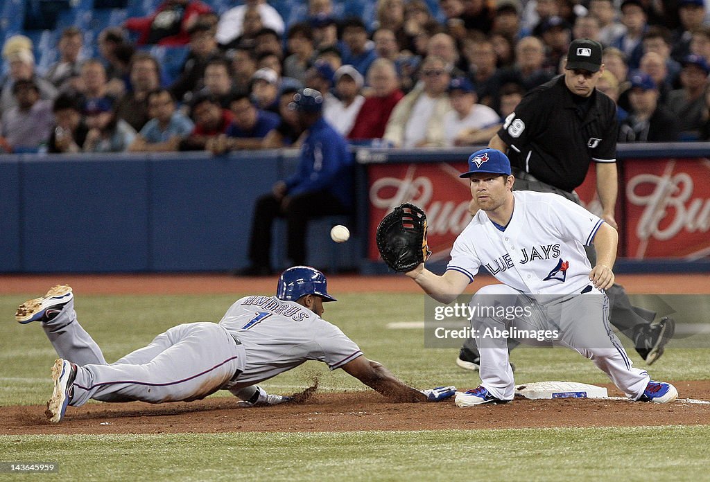 Texas Rangers Andrus Elvis Andrus of the Texas Rangers dives back safely to first base as ...