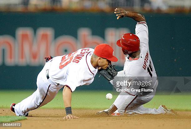 Justin Upton of the Arizona Diamondbacks steals second base in the sixth inning ahead of the throw to Ian Desmond of the Washington Nationals at...