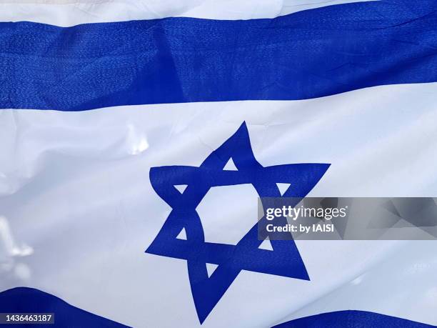 background of the israeli flag in the wind , full frame - israel flag stock pictures, royalty-free photos & images