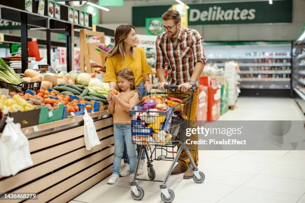 family in supermarket - market retail space stock pictures, royalty-free photos & images