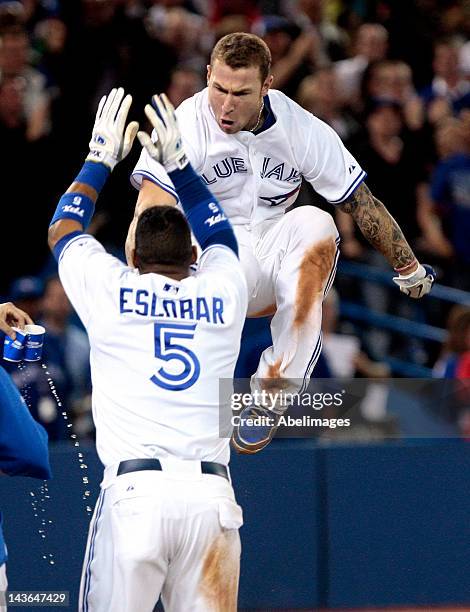 Brett Lawrie of the Toronto Blue Jays celebrates his game-winning home run in the 9th inning with Yunel Escobar of the Toronto Blue Jays against the...