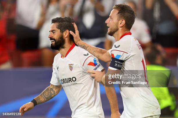 Isco celebrates with Ivan Rakitic of Sevilla FC after scoring their team's second goal during the UEFA Champions League group G match between Sevilla...
