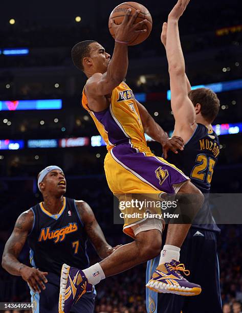 Ramon Sessions of the Los Angeles Lakers goes in for a layup in front of Timofey Mozgov and Al Harrington of the Denver Nuggets during Game Two of...