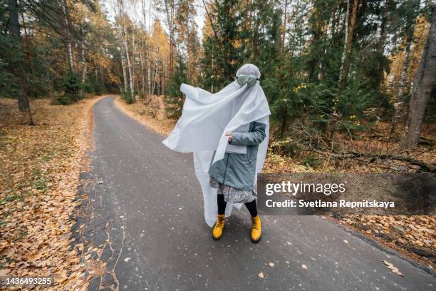 halloween ghosts on the autumn road - funny facial expression stock pictures, royalty-free photos & images