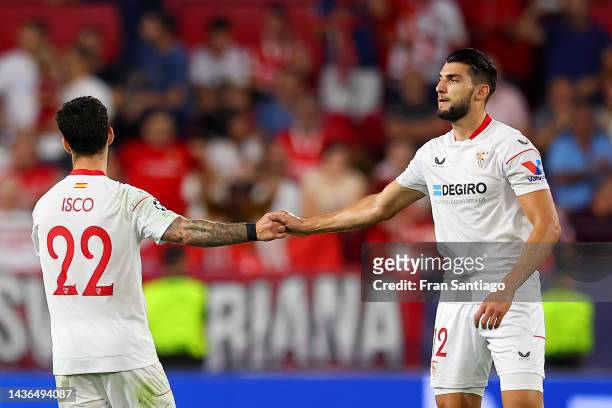 Isco celebrates with Rafa Mir of Sevilla FC after scoring their team's second goal during the UEFA Champions League group G match between Sevilla FC...