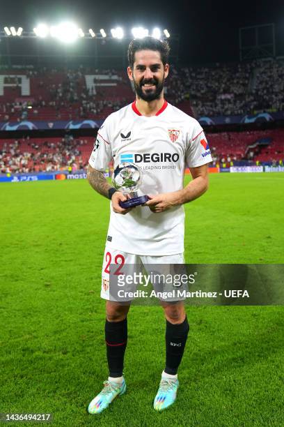 Isco of Sevilla FC poses for a photo with the PlayStation Player Of The Match trophy after their sides victory during the UEFA Champions League group...