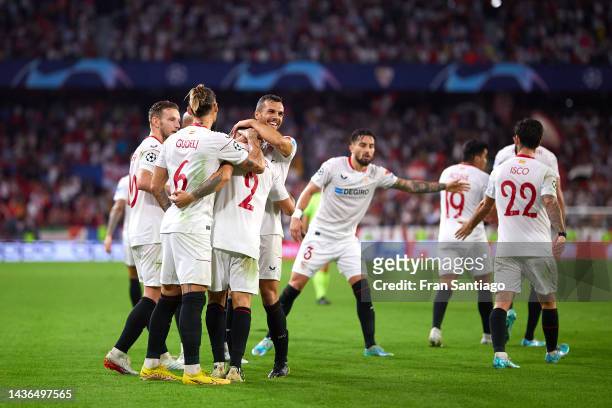 Gonzalo Montiel of Sevilla celebrates scoring their teams third goal with team mates during the UEFA Champions League group G match between Sevilla...