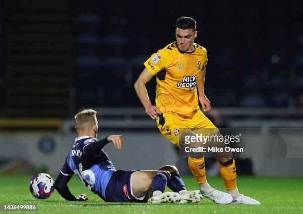 Lloyd Jones of Cambridge United battles for possession with Jason McCarthy of Wycombe Wanderers during the Sky Bet League One between Wycombe...