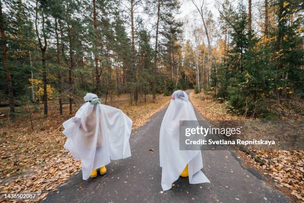 halloween ghosts on the autumn road - funny facial expression stock pictures, royalty-free photos & images