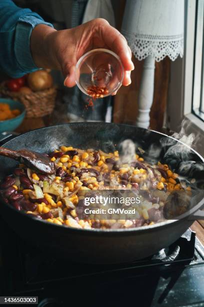 preparing burrito butternut squash boats - red beans stock pictures, royalty-free photos & images