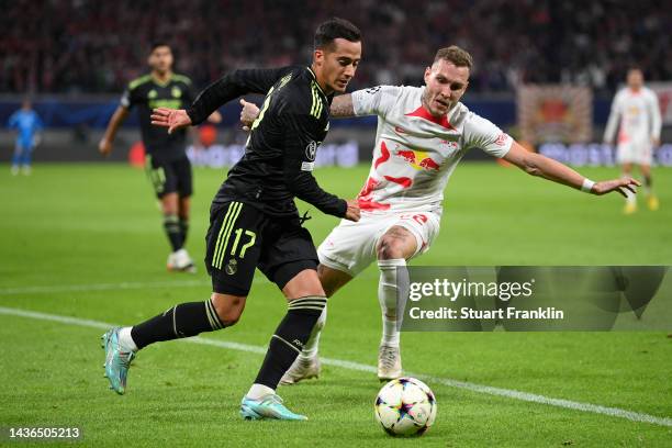 Lucas Vazquez of Real Madrid is challenged by David Raum of RB Leipzig during the UEFA Champions League group F match between RB Leipzig and Real...