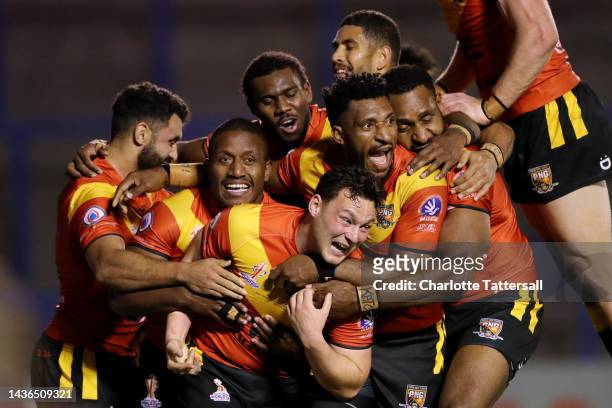 Lachlan Lam of Papua New Guinea celebrates with team mates after scoring their sides fifth try during Rugby League World Cup 2021 Pool D match...