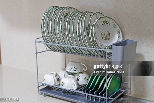 cups and plates on drying board at kitchen - geschirr vintage stock-fotos und bilder