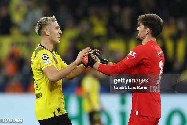 Gregor Kobel celebrates with Nico Schlotterbeck of Borussia Dortmund after saving a penalty by Riyad Mahrez of Manchester City during the UEFA...