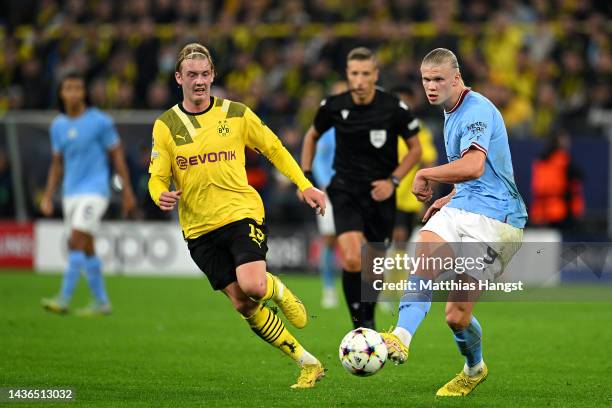 Erling Haaland of Manchester City is challenged by Julian Brandt of Borussia Dortmund during the UEFA Champions League group G match between Borussia...