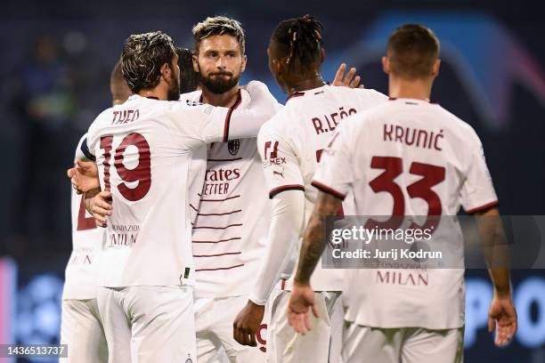 Olivier Giroud of AC Milan celebrates scoring their side's third goal from a penalty with teammates during the UEFA Champions League group E match...