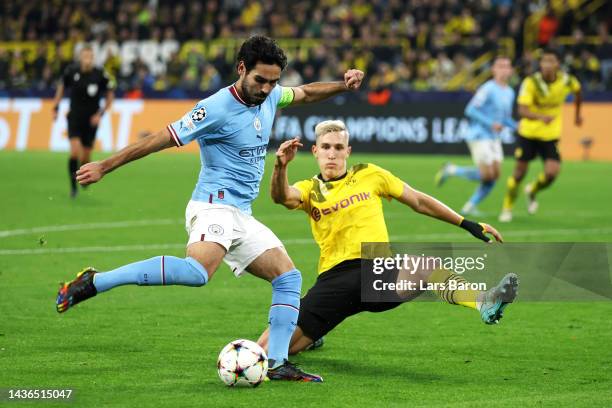 Ilkay Gundogan of Manchester City is challenged by Nico Schlotterbeck of Borussia Dortmund during the UEFA Champions League group G match between...