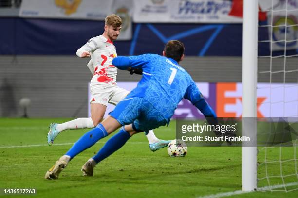 Timo Werner of RB Leipzig scores their side's third goal as Thibaut Courtois of Real Madrid attempts to make a save during the UEFA Champions League...